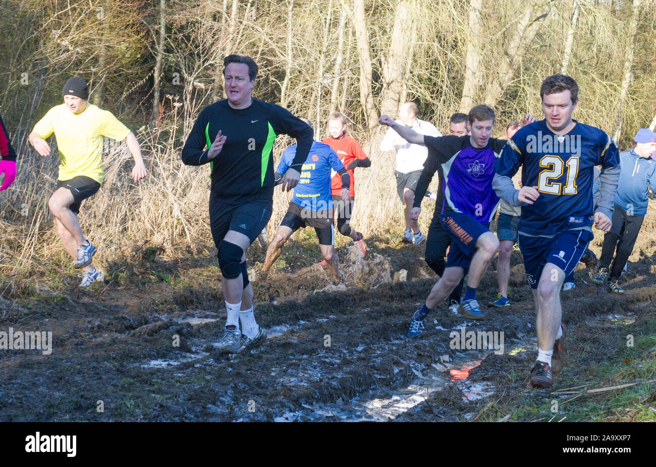 The Prime Minister David Cameron competing in the Great Brook Run in his Witney constituency village of Chadlington in December 2014. The Great Brook Run is an annual mile-long cross country run following  a path along the village stream called Coldron Brook passing through a 3-foot tunnel under a bridge. Stock Photo