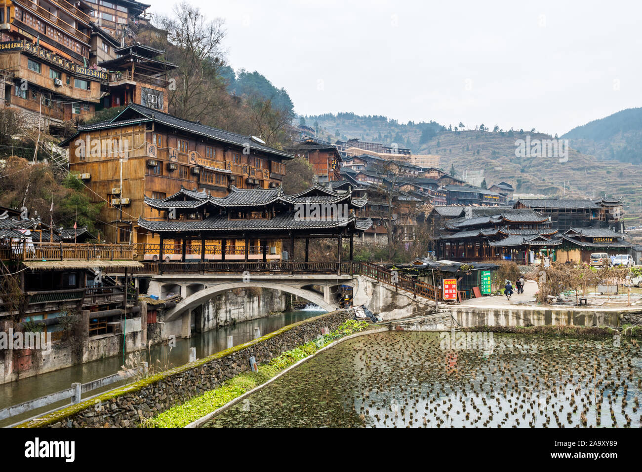 Traditional wooden building cluster at the bank of river of Xijiang Qianhu Miao Village (The One Thousand Household Miao Village) ,  in southeastern G Stock Photo