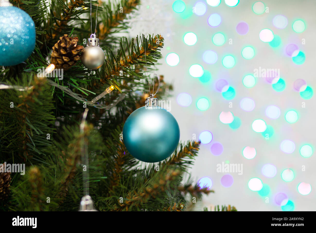 Beautiful green Christmas tree decorated with balls and garlands. Close ...