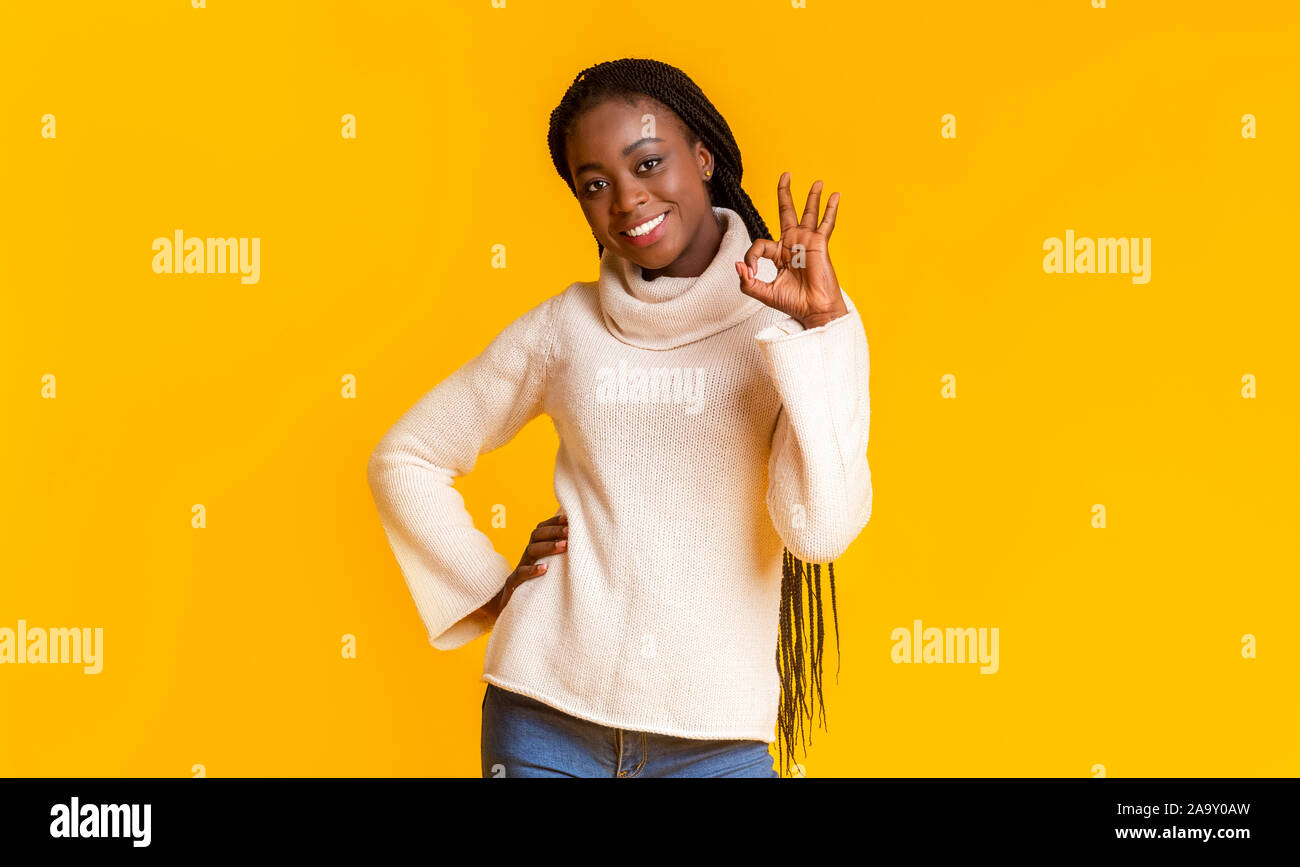 Happy black lady showing okay gesture over yellow background Stock ...