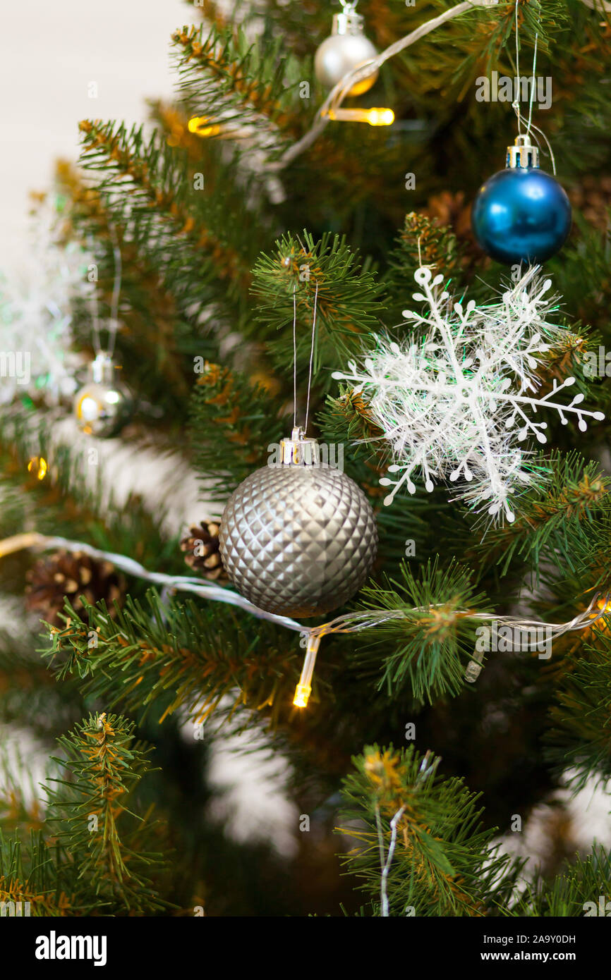 Beautiful green Christmas tree decorated with balls and garlands. Close ...