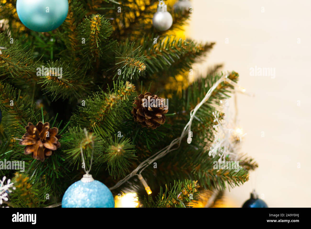 Beautiful green Christmas tree decorated with balls and garlands. Close ...