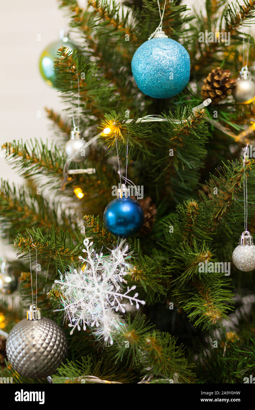 Beautiful green Christmas tree decorated with balls and garlands. Close ...