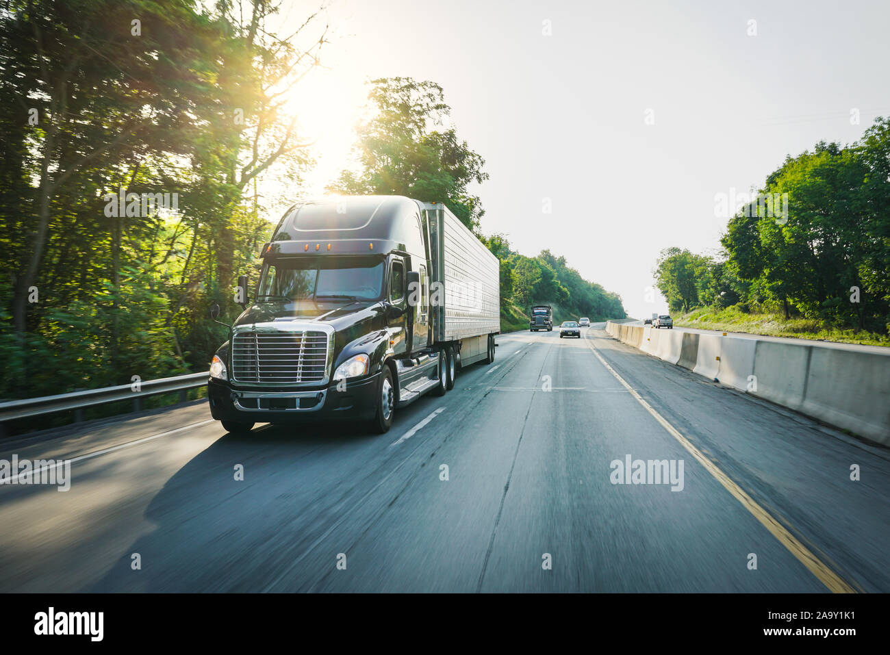 Commercial semi truck 18 wheeler on highway delivering freight Stock Photo