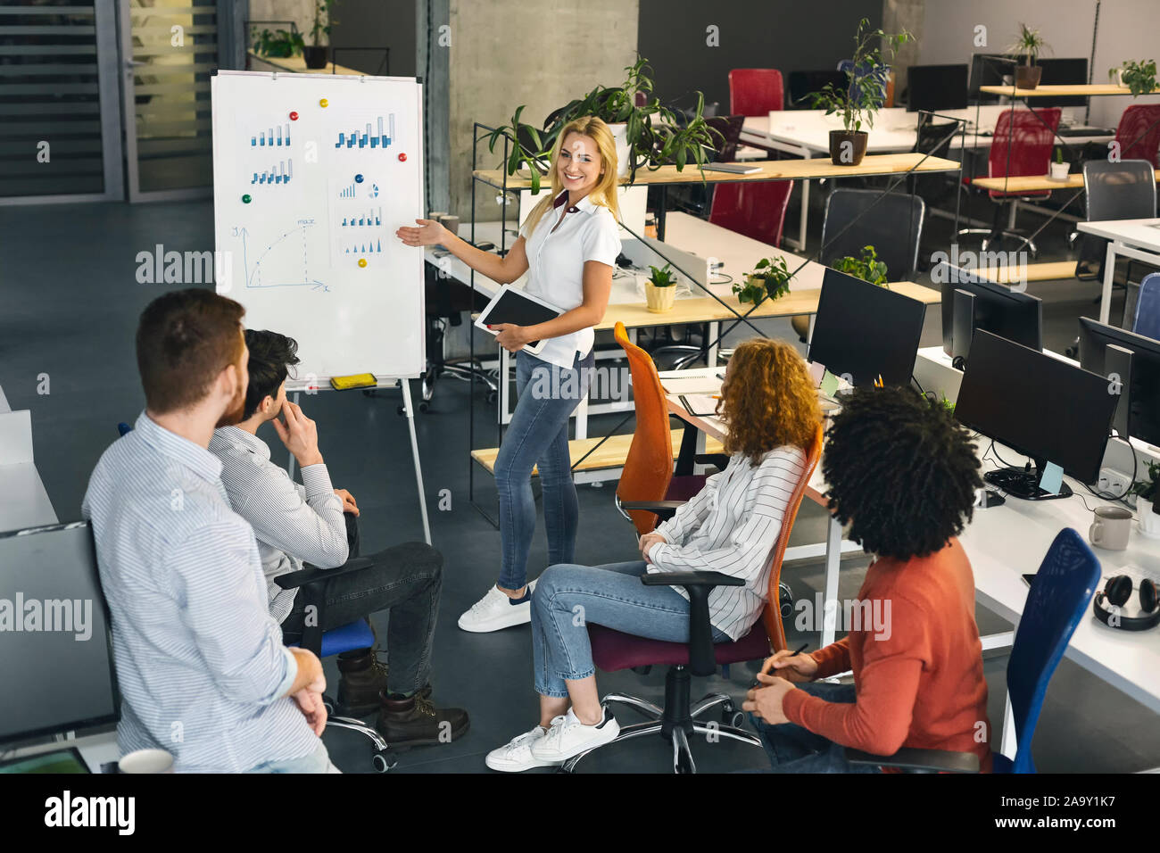 Young millennial team analyzing financial information at work Stock Photo