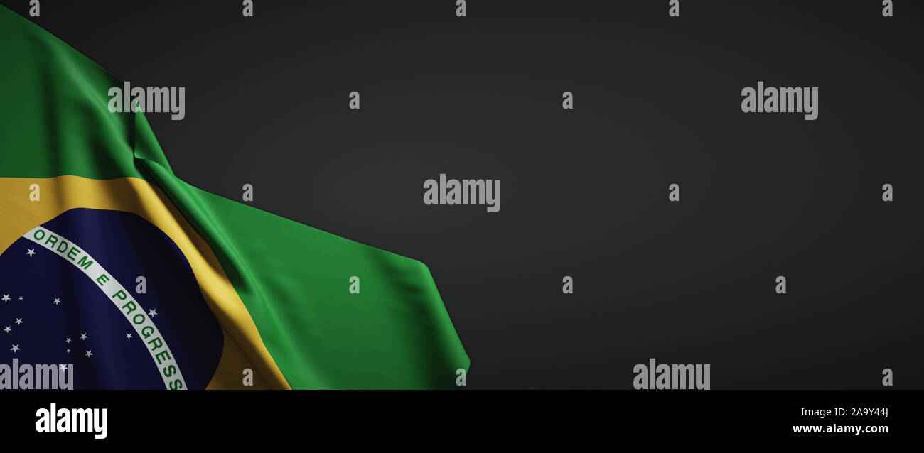 Brazil flag fabric on plain dark background Stock Photo