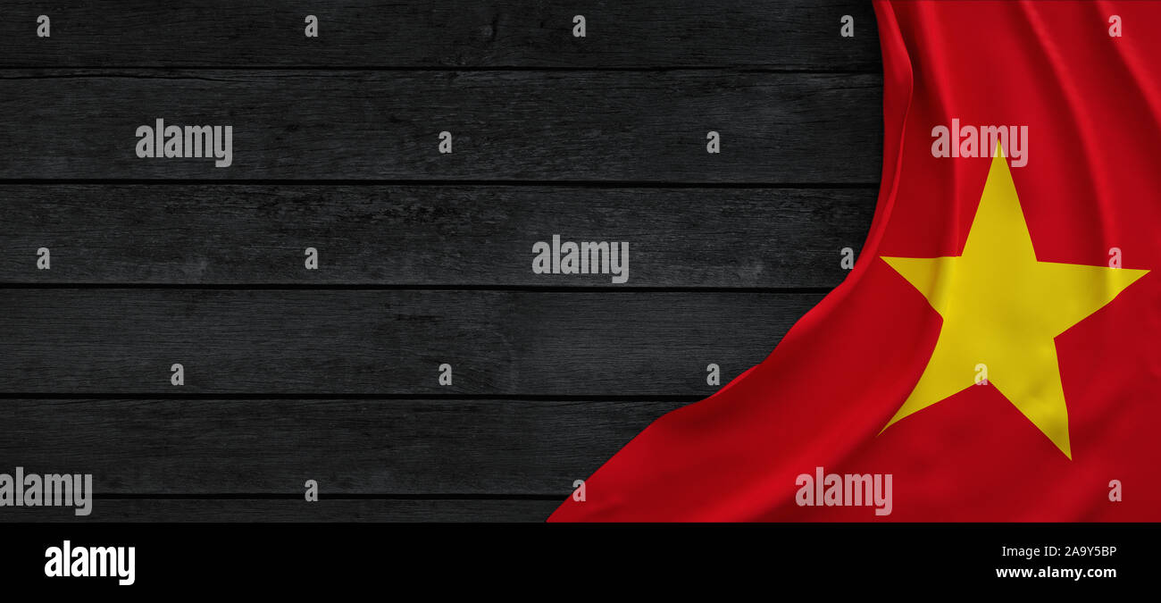 Flag of Vietnam, fabric on dark wood Stock Photo - Alamy
