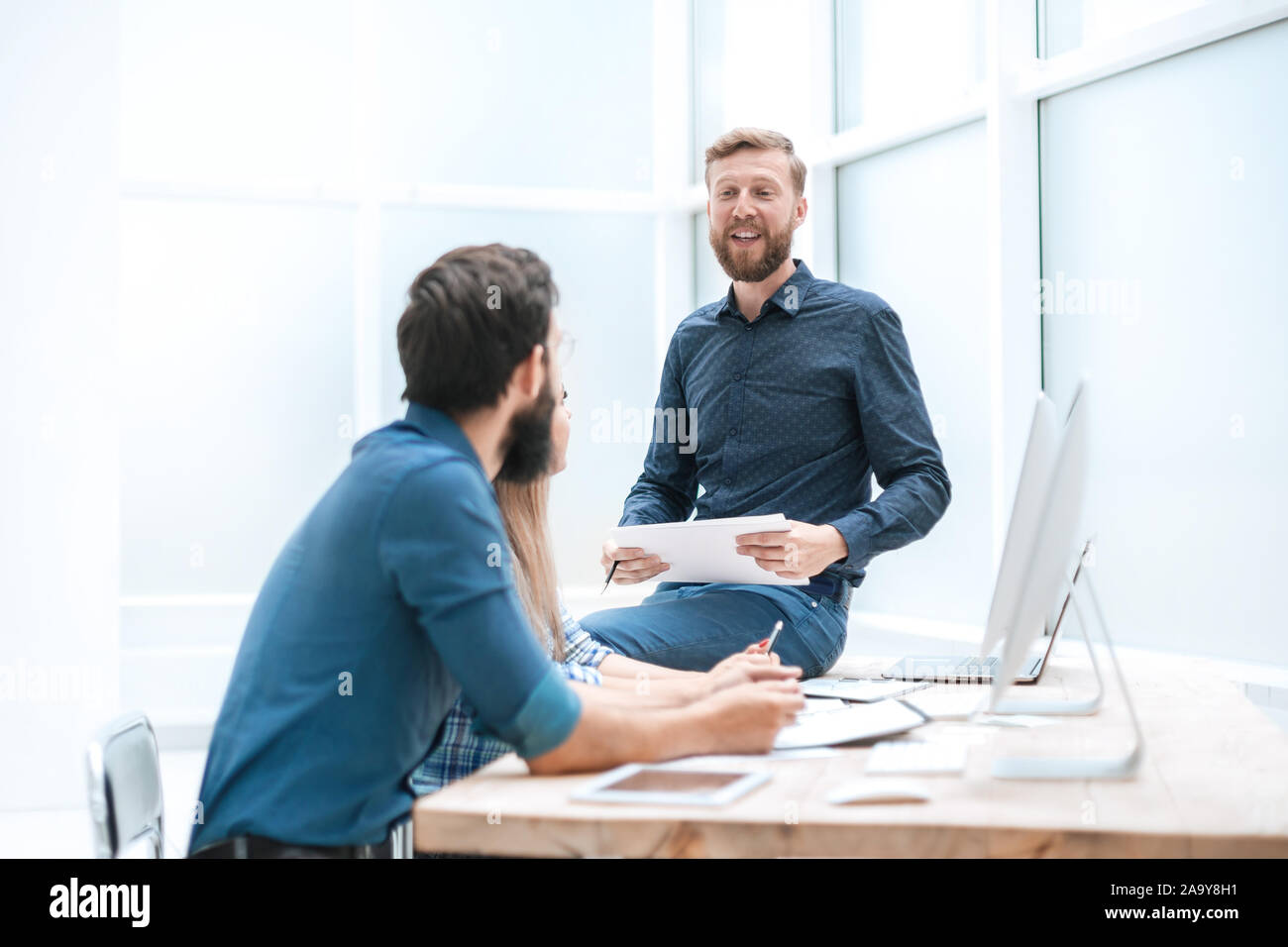 business team is discussing something at the workplace in the office Stock Photo