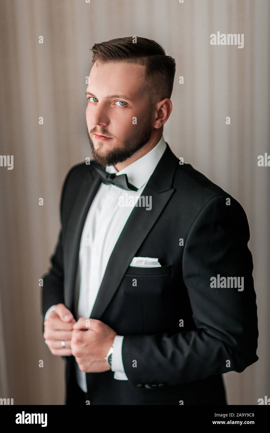 close up. serious man buttoning his jacket. Stock Photo