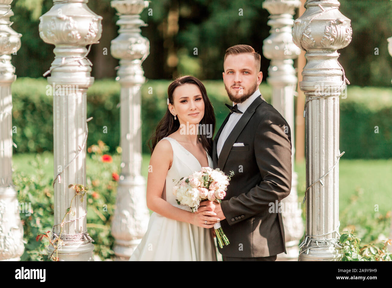 close up. bride and groom standing in an arched gazebo Stock Photo - Alamy