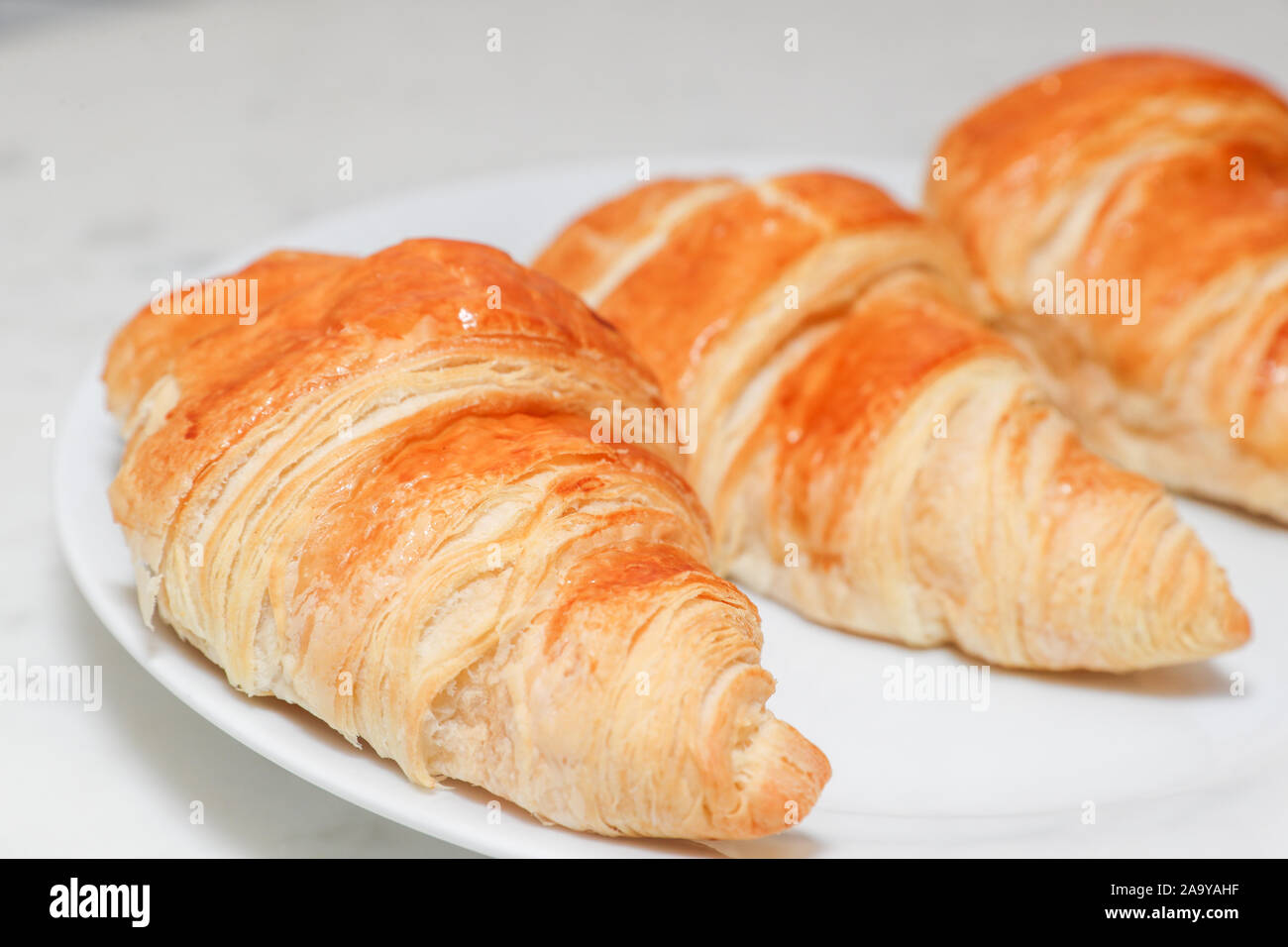 Plain croissant on white background - Image Stock Photo - Alamy