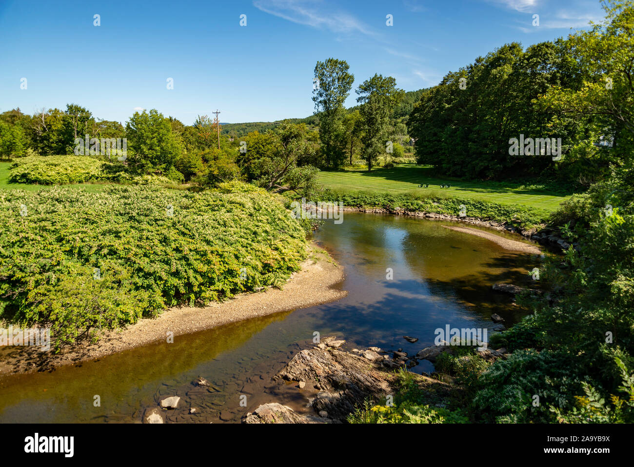 A colorful landcape reflected in the Little River in Stowe, Vermont