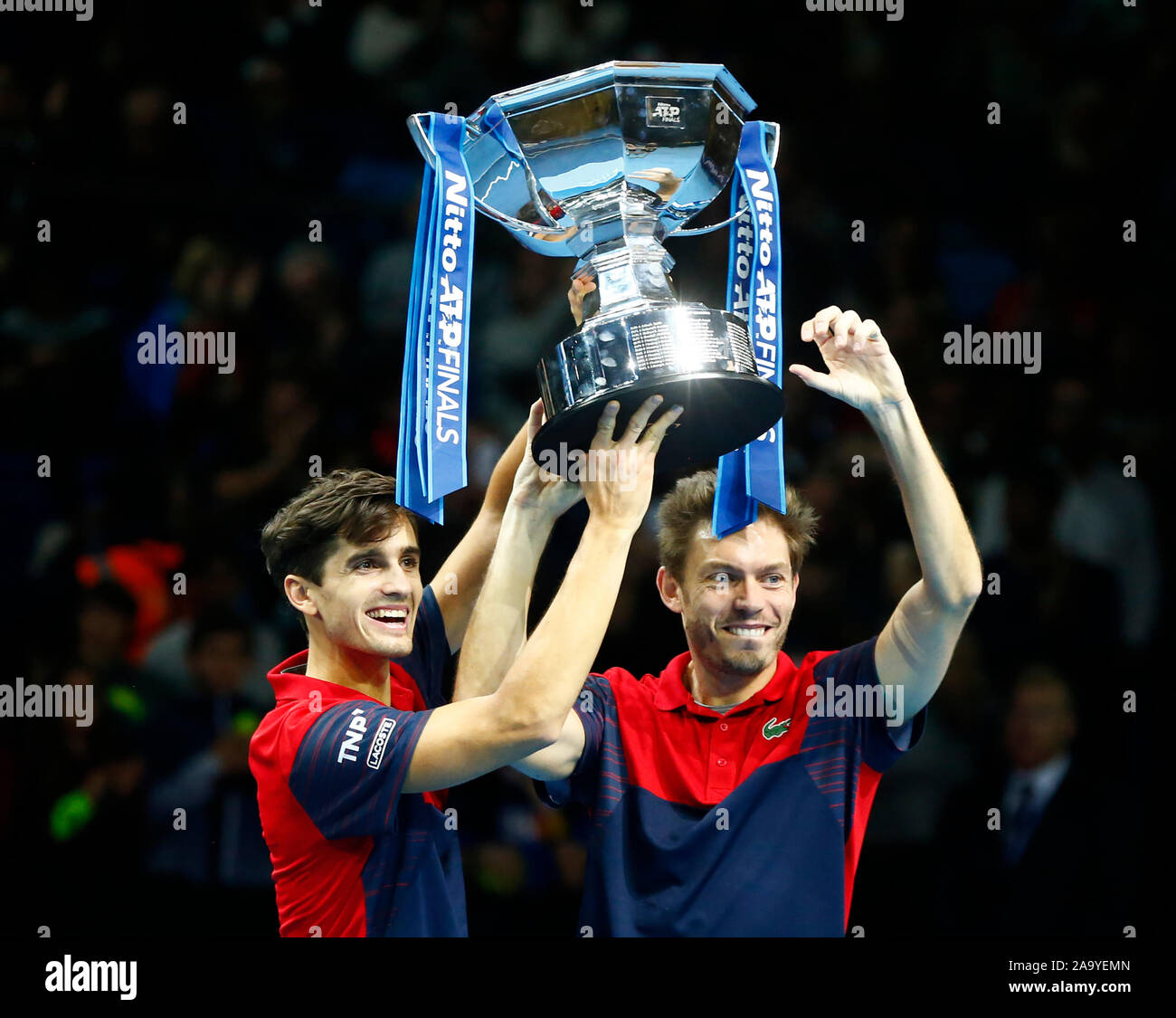LONDON, UNITED KINGDOM. NOVEMBER 17 Pierre-Hughes Herbert and Nicolas Mahut (FRA) left the winners Trophy during Doubles Championship Final match Pier Stock Photo