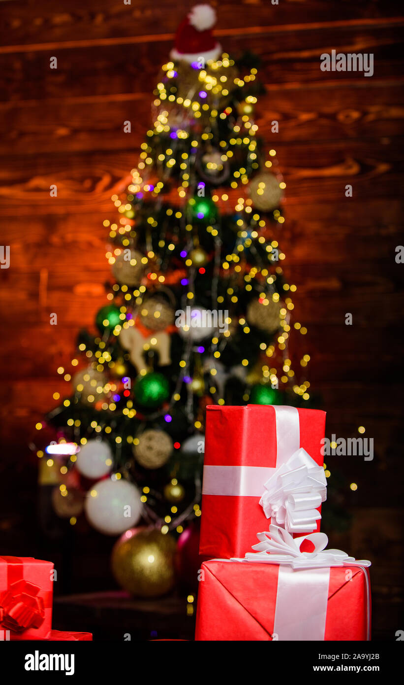 Christmas preparation. present boxes at christmas tree. happy new year. celebrate xmas at home. winter holiday shopping. shopping sales. gift delivery. surprise from santa. Christmas online shopping. Stock Photo