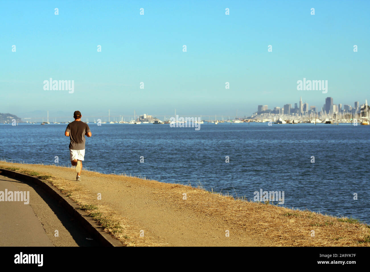 Man running away near Tiburon, California Behind San Francisco skyline Stock Photo