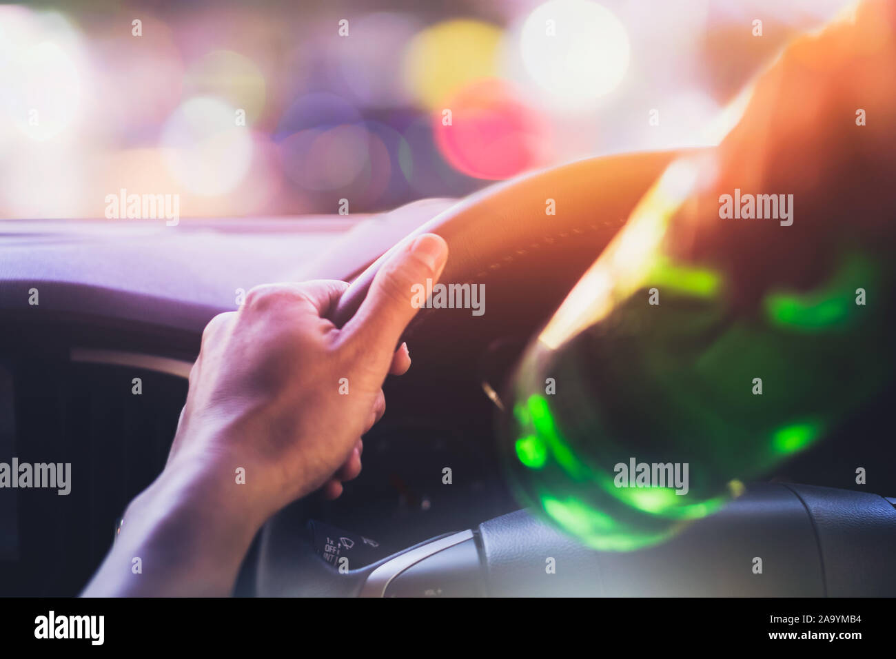 Drinking and driving ,man drinking alcohol while driving car after