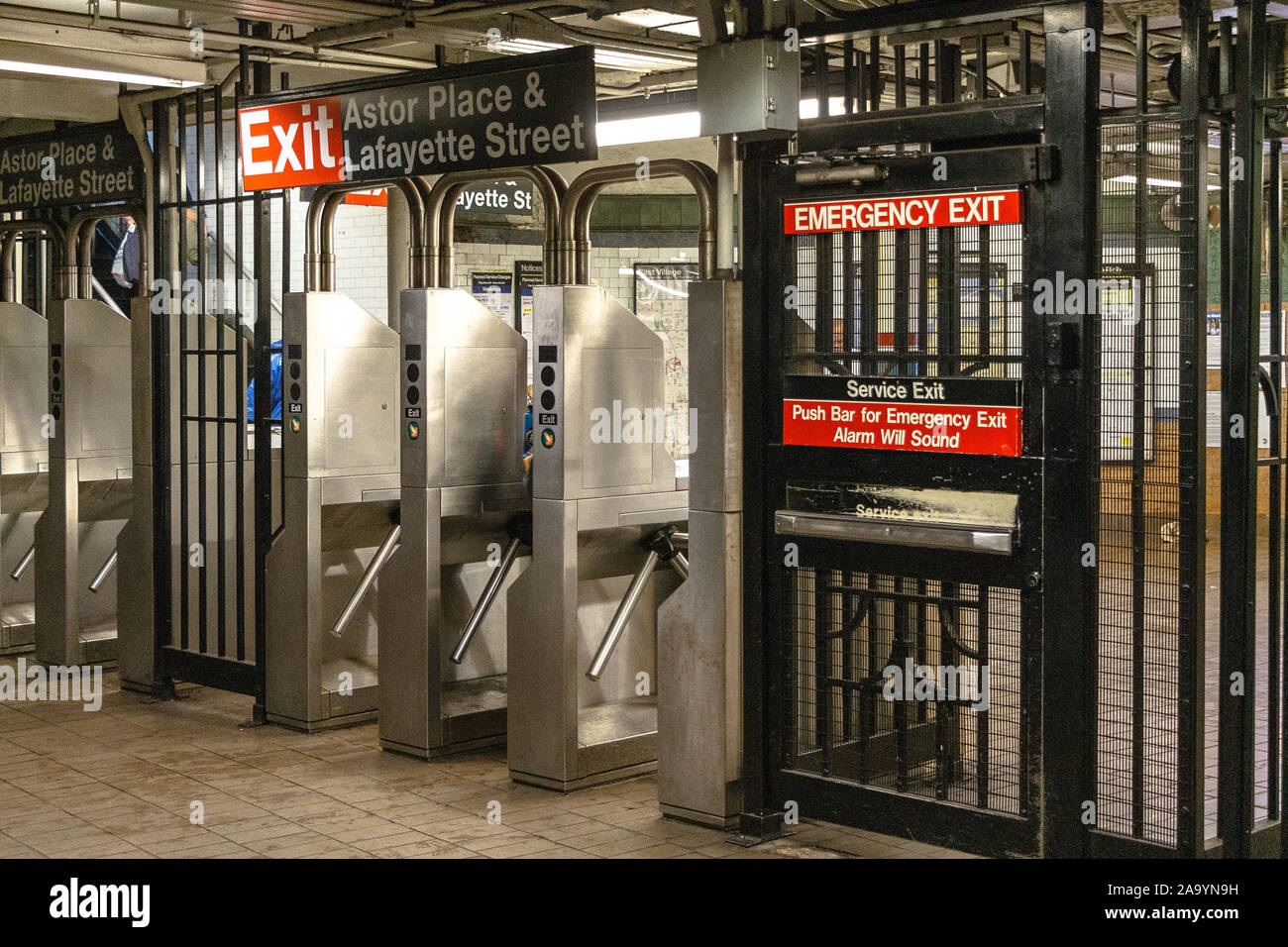Turnstiles and an emergency exit on the New York City subway at Astor Place and Lafayette Street Stock Photo