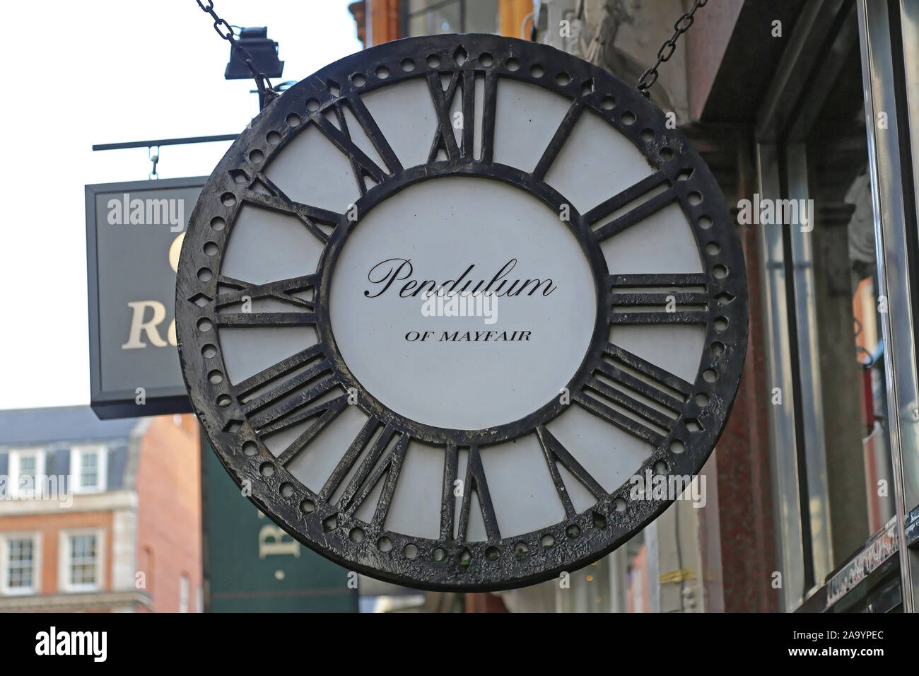 London, United Kingdom - November 21, 2013: Pendulum of Mayfair Antique Clocks and Furniture Specialists at Maddox Street in London., UK. Stock Photo