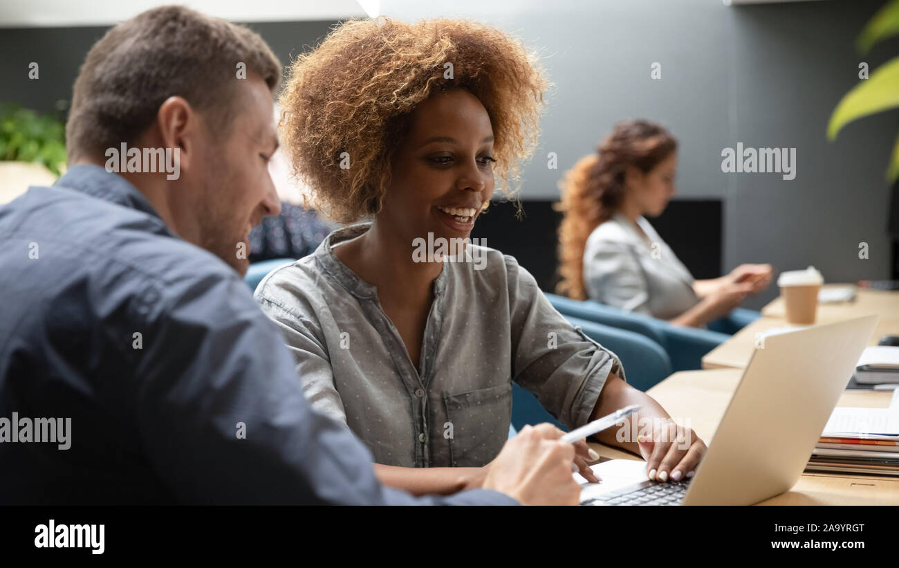Smiling multiracial diverse colleagues working together at office Stock ...