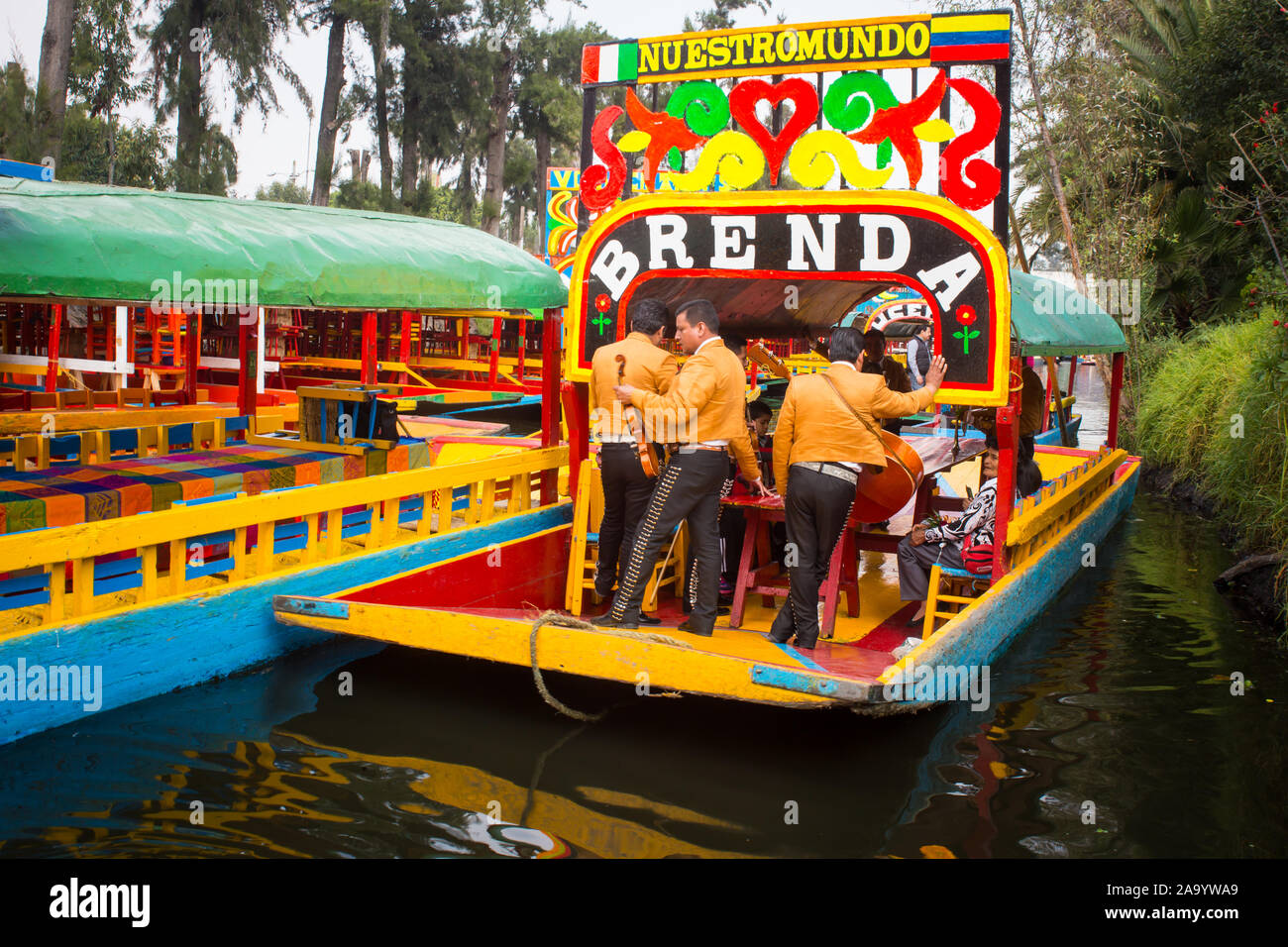 Mexican workers painting colorful trajineras boats in xochimilco, Mexico City, Mexico. 2016-12-19. Stock Photo
