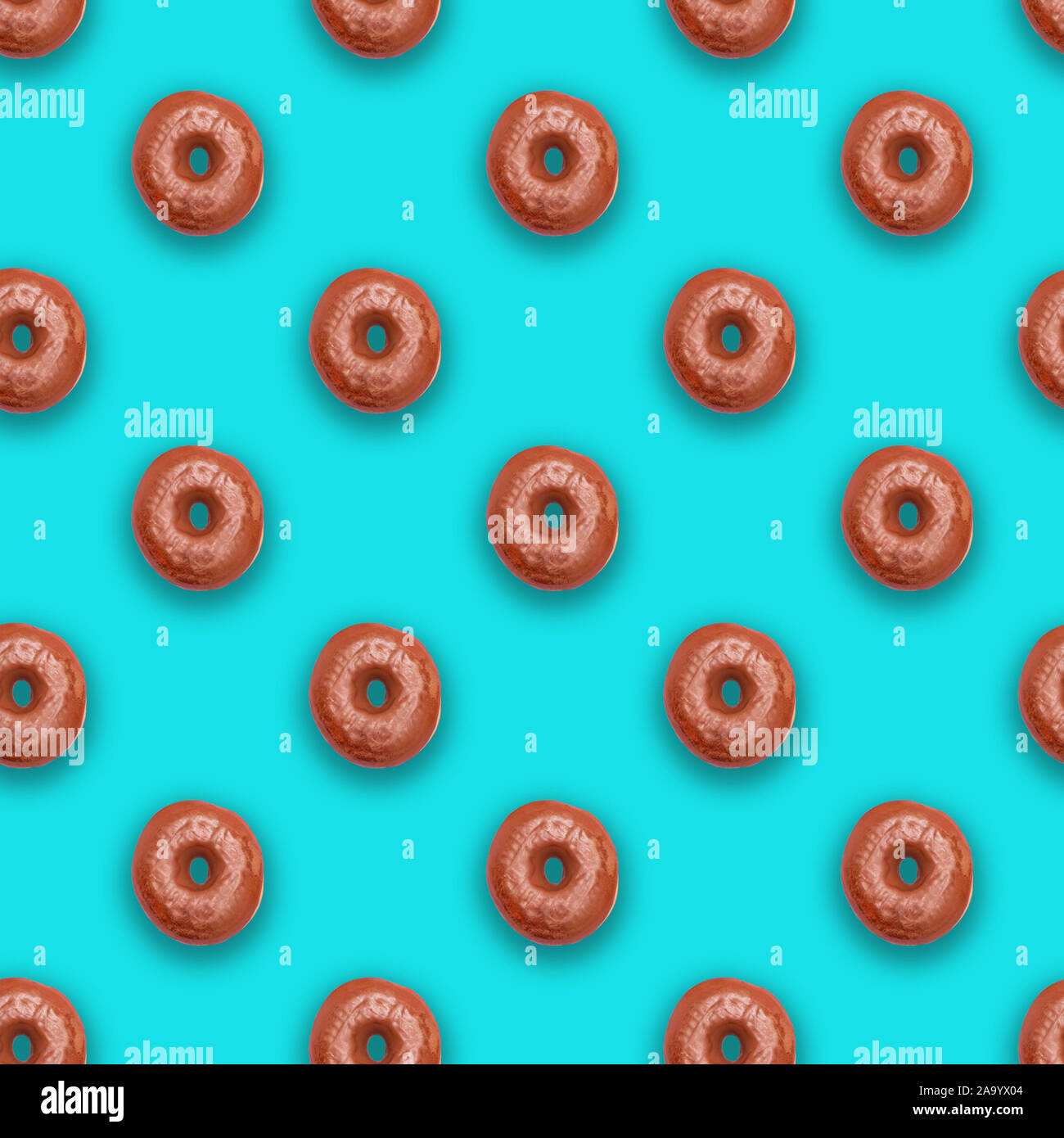 Chocolate glazed doughnuts (donuts) on soft turquoise background Stock Photo