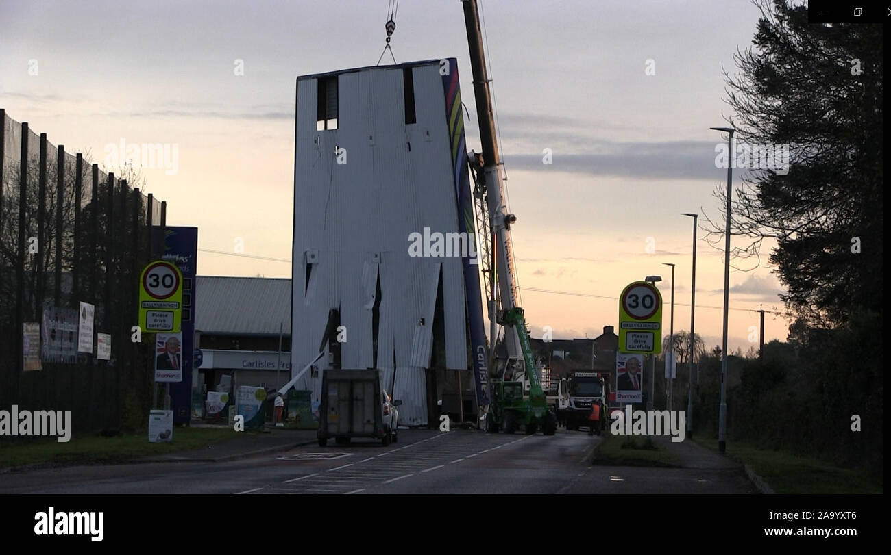 A recovery crane removes the forecourt roof onto the road below following a raid at Carlisles filling station and convenience store on Belfast Road, Ballynahinch, Co Down, which happened at around 5.30am this morning, in one of a series of ATM raids in Northern Ireland. Stock Photo