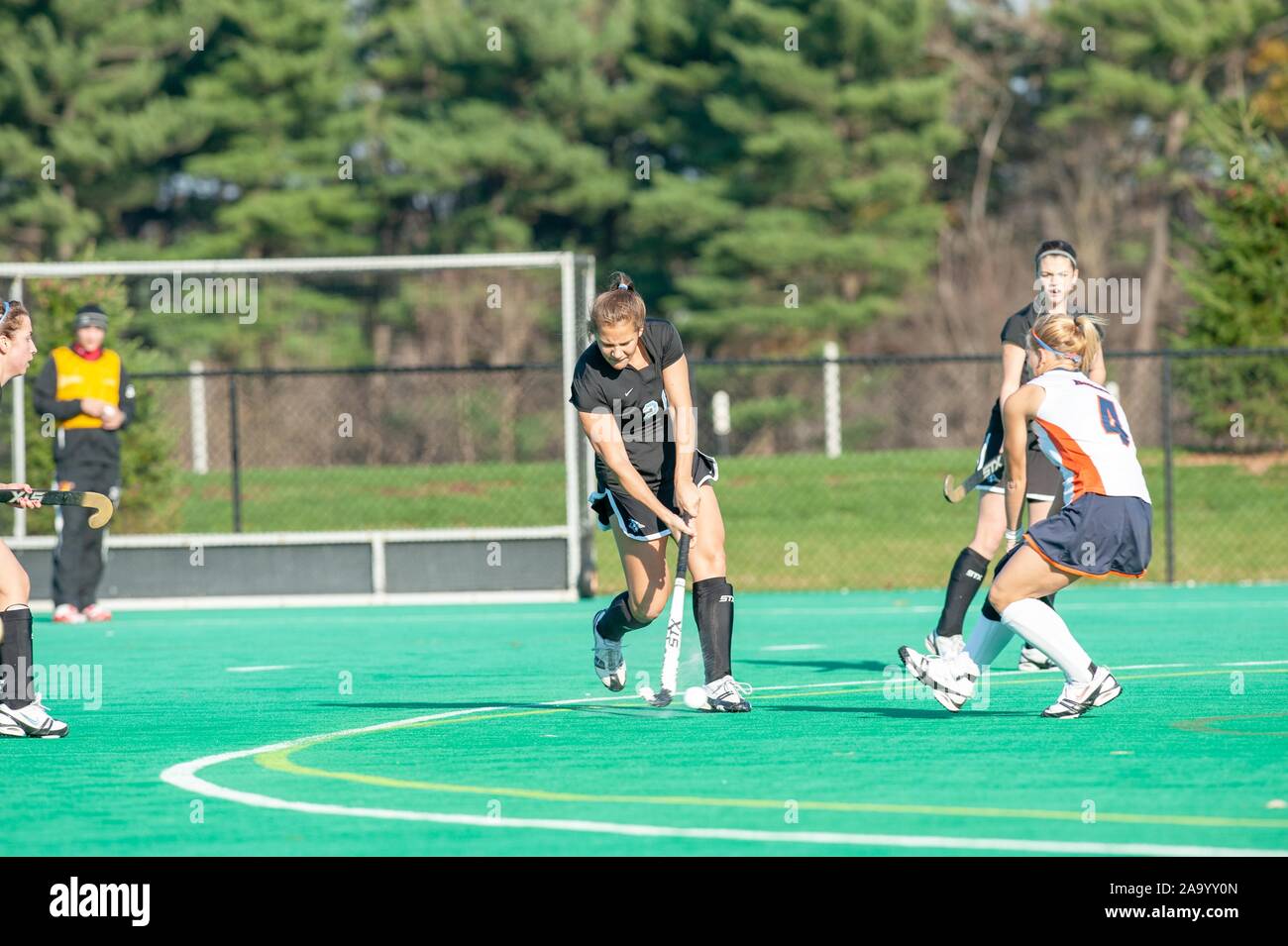 A Johns Hopkins University Women's Field Hockey member defends the ball from an opposing player during a Centennial Conference semifinals match with Gettysburg College, November 7, 2009. From the Homewood Photography Collection. () Stock Photo