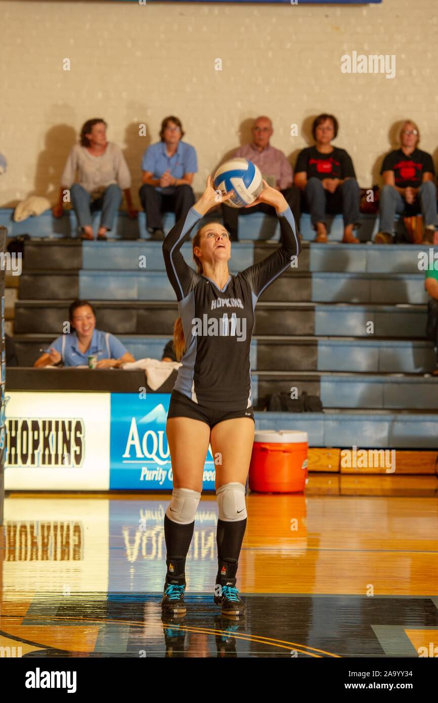 Full-length shot of a Johns Hopkins University Women's Volleyball player catching the ball during a match with Haverford College, October 2, 2010. From the Homewood Photography Collection. () Stock Photo