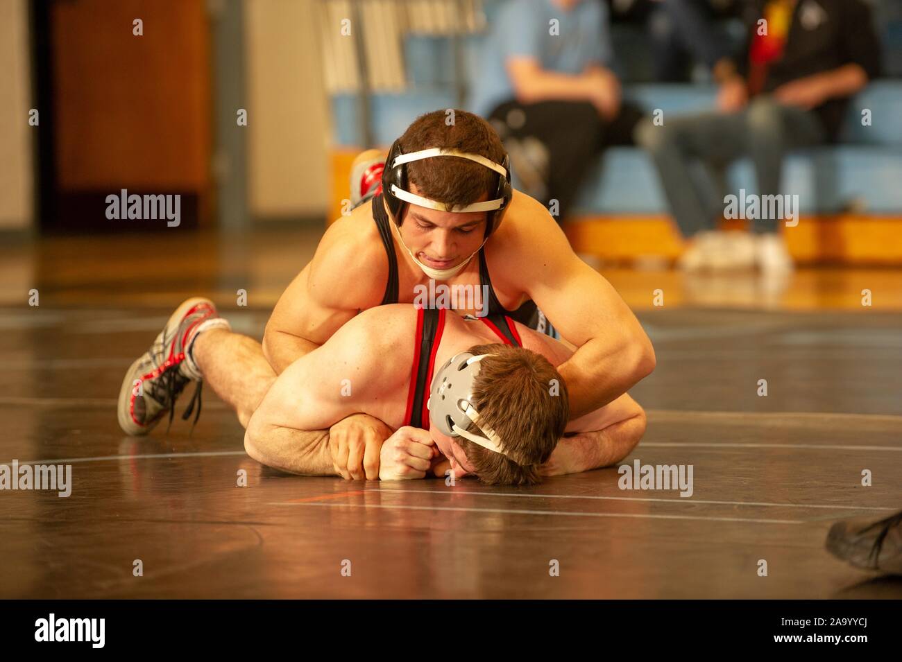 A Johns Hopkins University Men's Wrestling team member holds an opponent in a lock during a match with Muhlenberg and Ursinus Colleges, January 23, 2010. From the Homewood Photography Collection. () Stock Photo