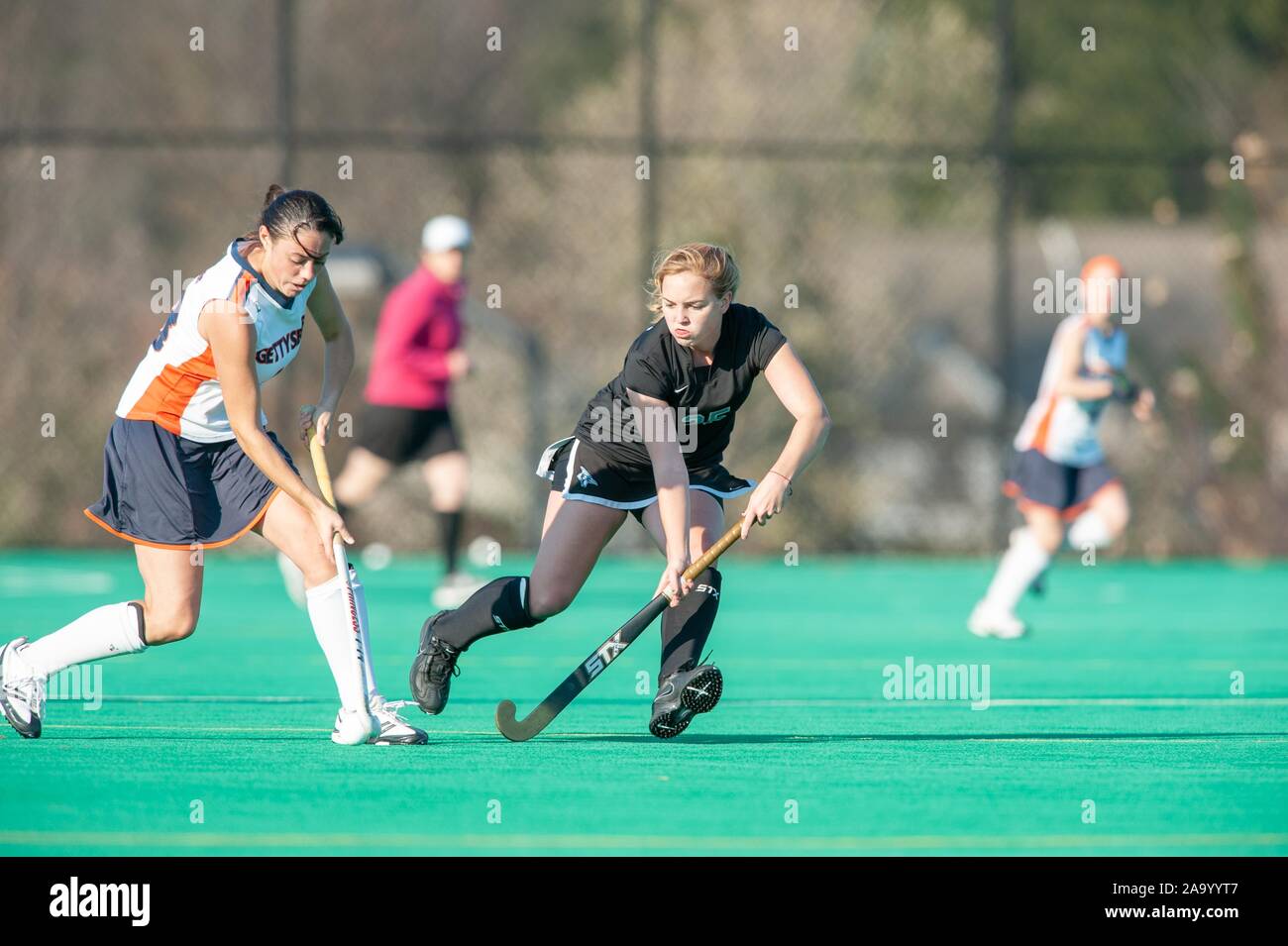 A Johns Hopkins University Women's Field Hockey member tries to take the ball from an opposing player during a Centennial Conference semifinals match with Gettysburg College, November 7, 2009. From the Homewood Photography Collection. () Stock Photo
