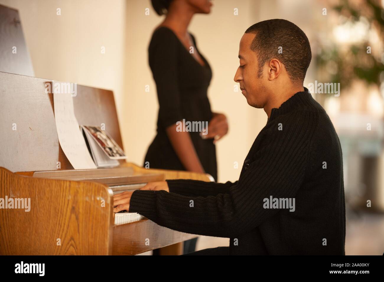 A singer and pianist perform a musical event during opening festivities for Black History Month at the Johns Hopkins University in Baltimore, Maryland, 2009. From the Homewood Photography collection. () Stock Photo
