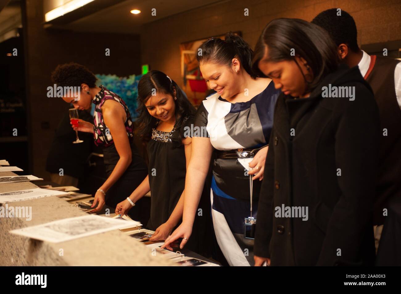 Guests view papers on a table during a Black History Month event at the Johns Hopkins University in Baltimore, Maryland, January 31, 2009. From the Homewood Photography collection. () Stock Photo