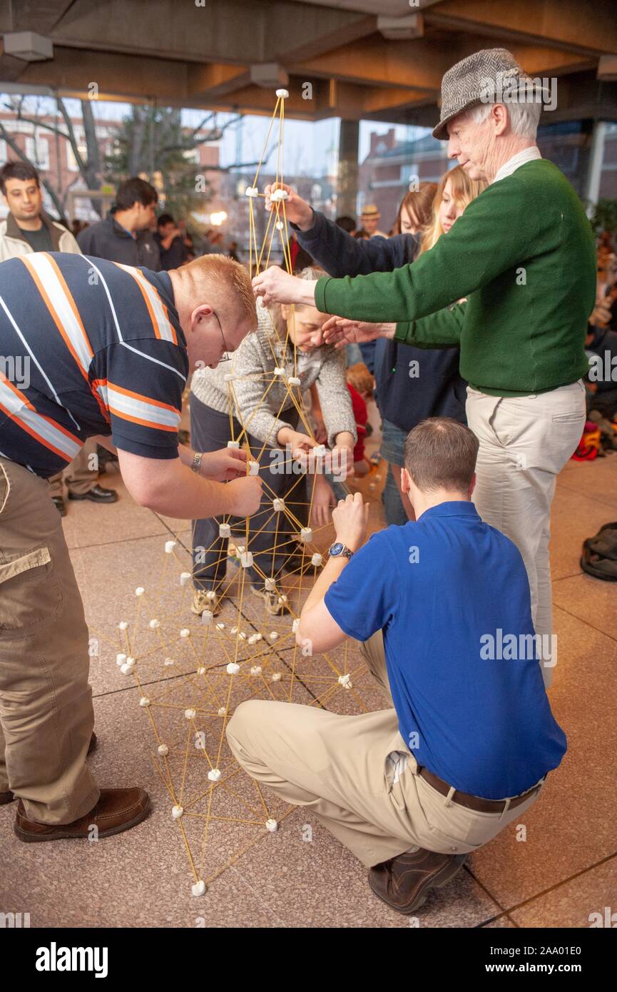 Mid shot of a team building a tower constructed from spaghetti and marshmallows during the annual Whiting School of Engineering Tower of Power event, at the Johns Hopkins University, Baltimore, Maryland, February 16, 2009. From the Homewood Photography Collection. () Stock Photo