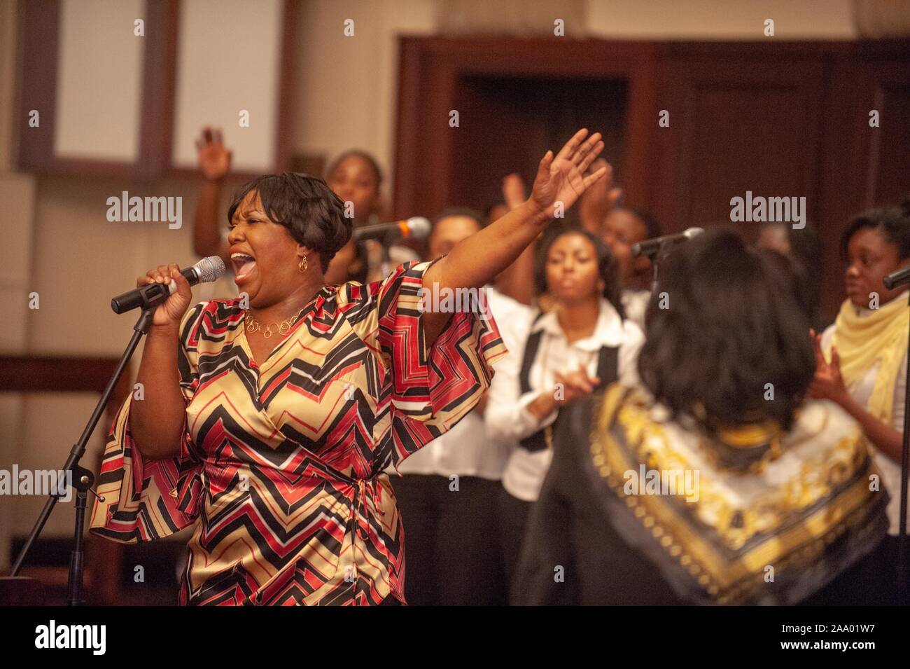 Three-quarter length view of performers, singing and clapping, during a gospel jubilee event associated with Black History Month at the Johns Hopkins University, Baltimore, Maryland, February 21, 2009. From the Homewood Photography Collection. () Stock Photo