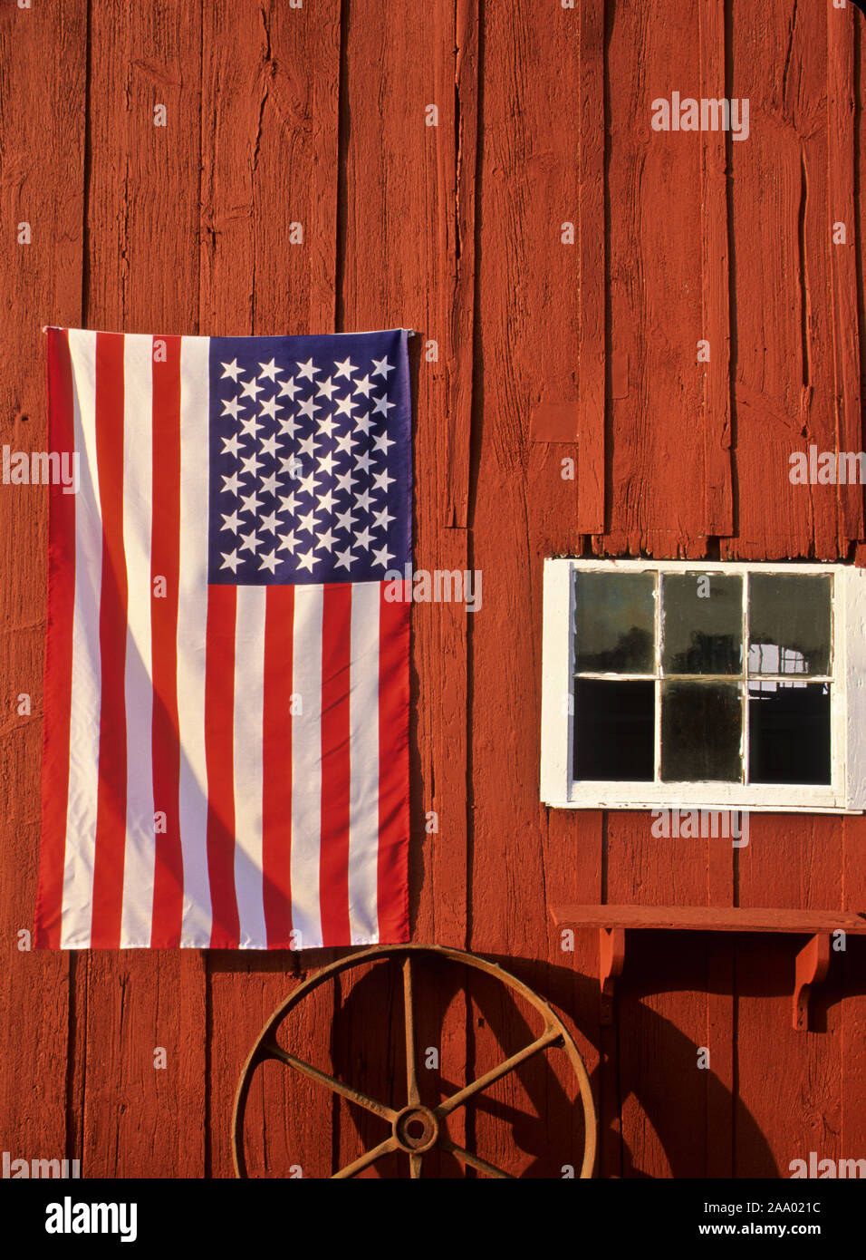 American flag on a red barn, farm in New Jersey, USA, US flag  United States, vertical farming vintage farming vertical dusk pt Stock Photo