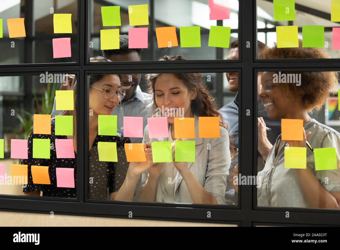 Diverse teammates satisfied with working process at office. Stock Photo