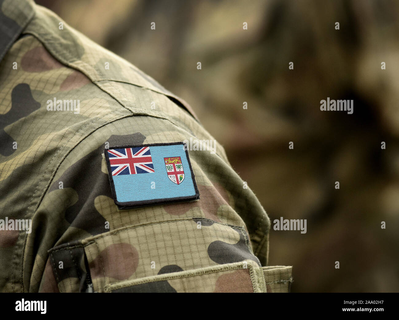 Flag of Fiji on military uniform. Army, armed forces, soldiers. Collage. Stock Photo