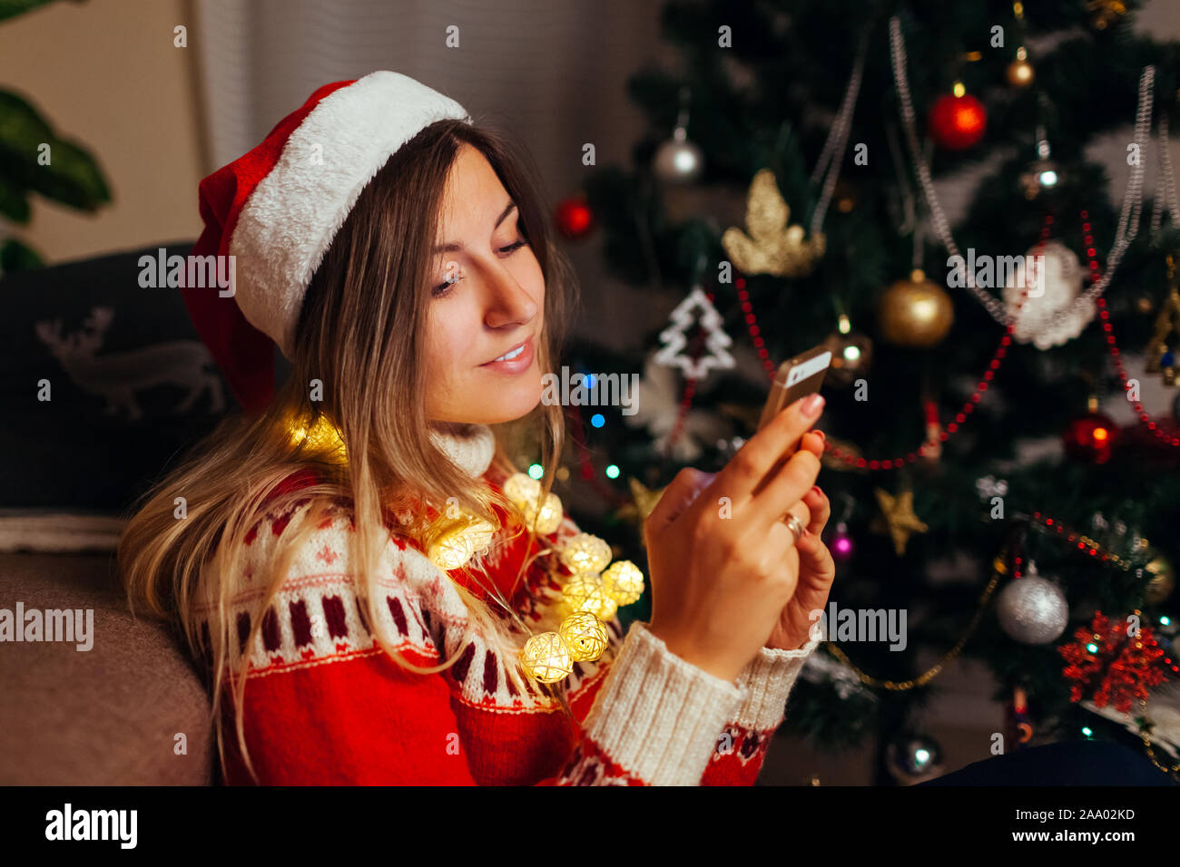 Woman hanging in Internet for Christmas using smartphone. Girl ...