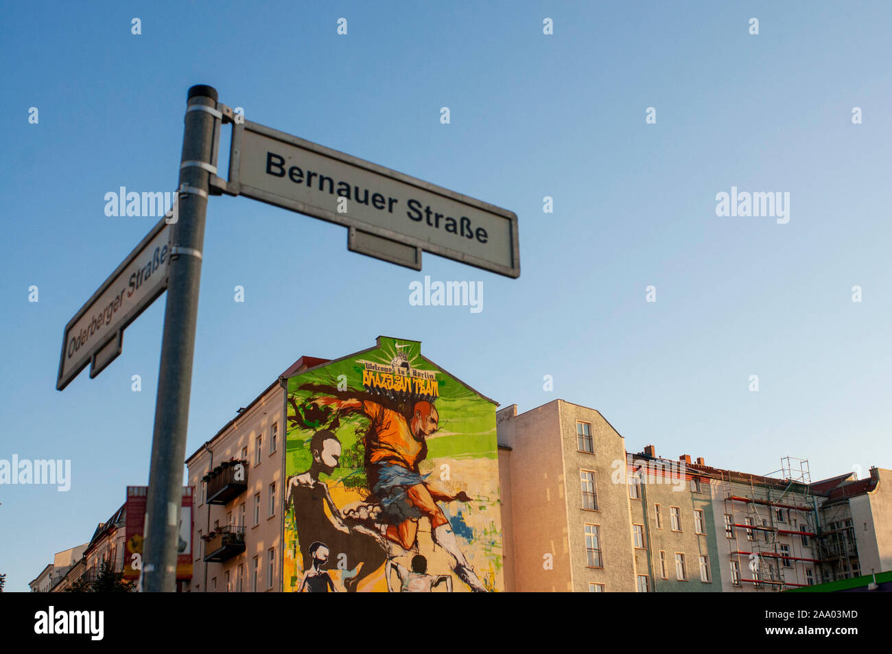 Sign street and Graffiti in a house near the Mauerpark, Berlin in evening light Germany. Wellcome to Belin, brazilian team. Joga bonito. Mauerpa Stock Photo