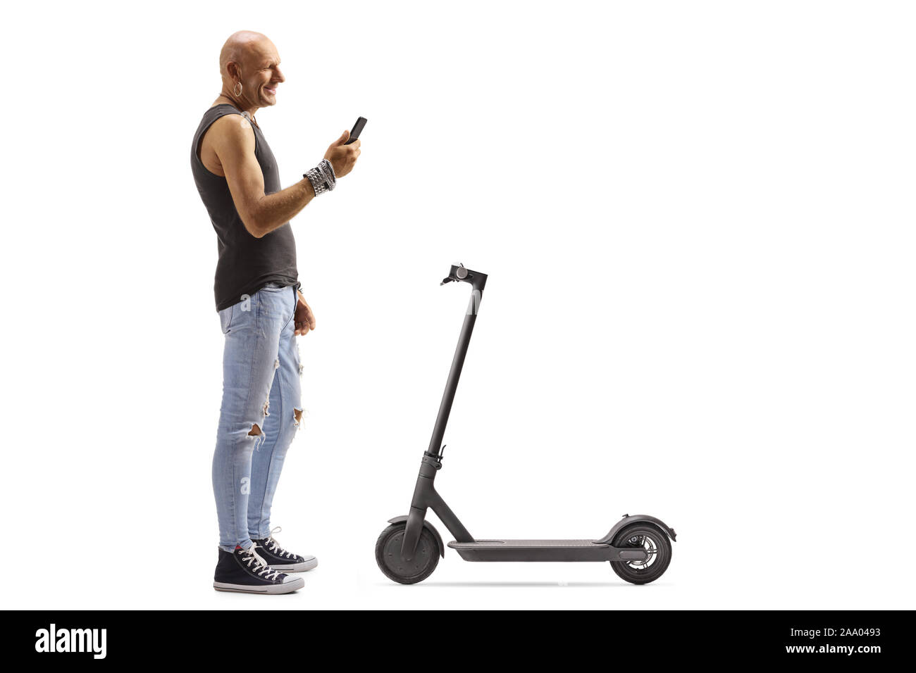 Full length profile shot of a bald male hipster renting a scooter with a mobile phone application isolated on white background Stock Photo