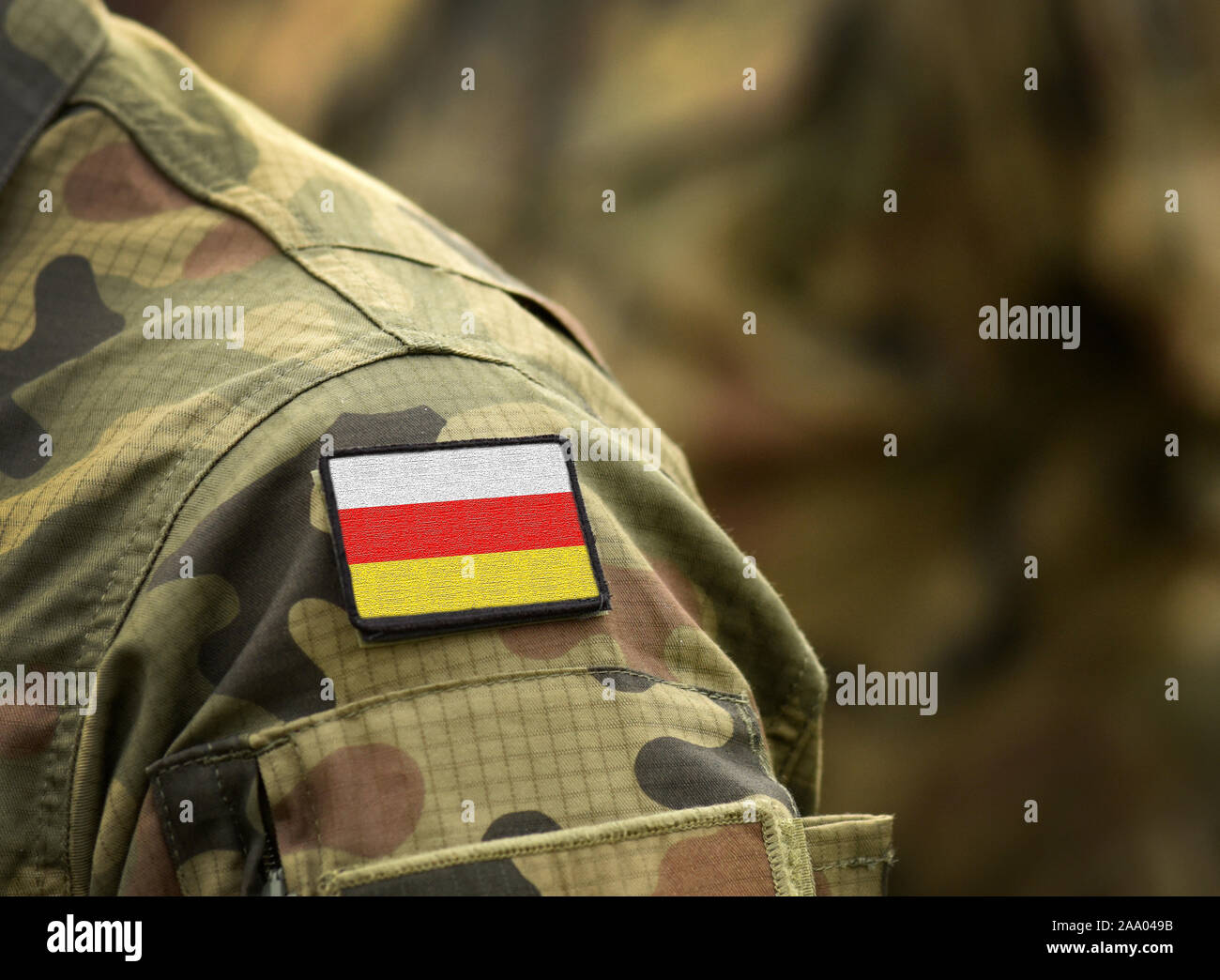 Flag of South Ossetia on military uniform. Army, armed forces, soldiers. Collage. Stock Photo
