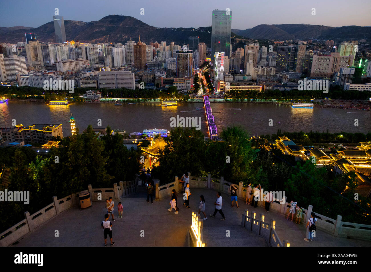 The Yellow River or Huang He in Lanzhou with the city skyline at sunset Stock Photo