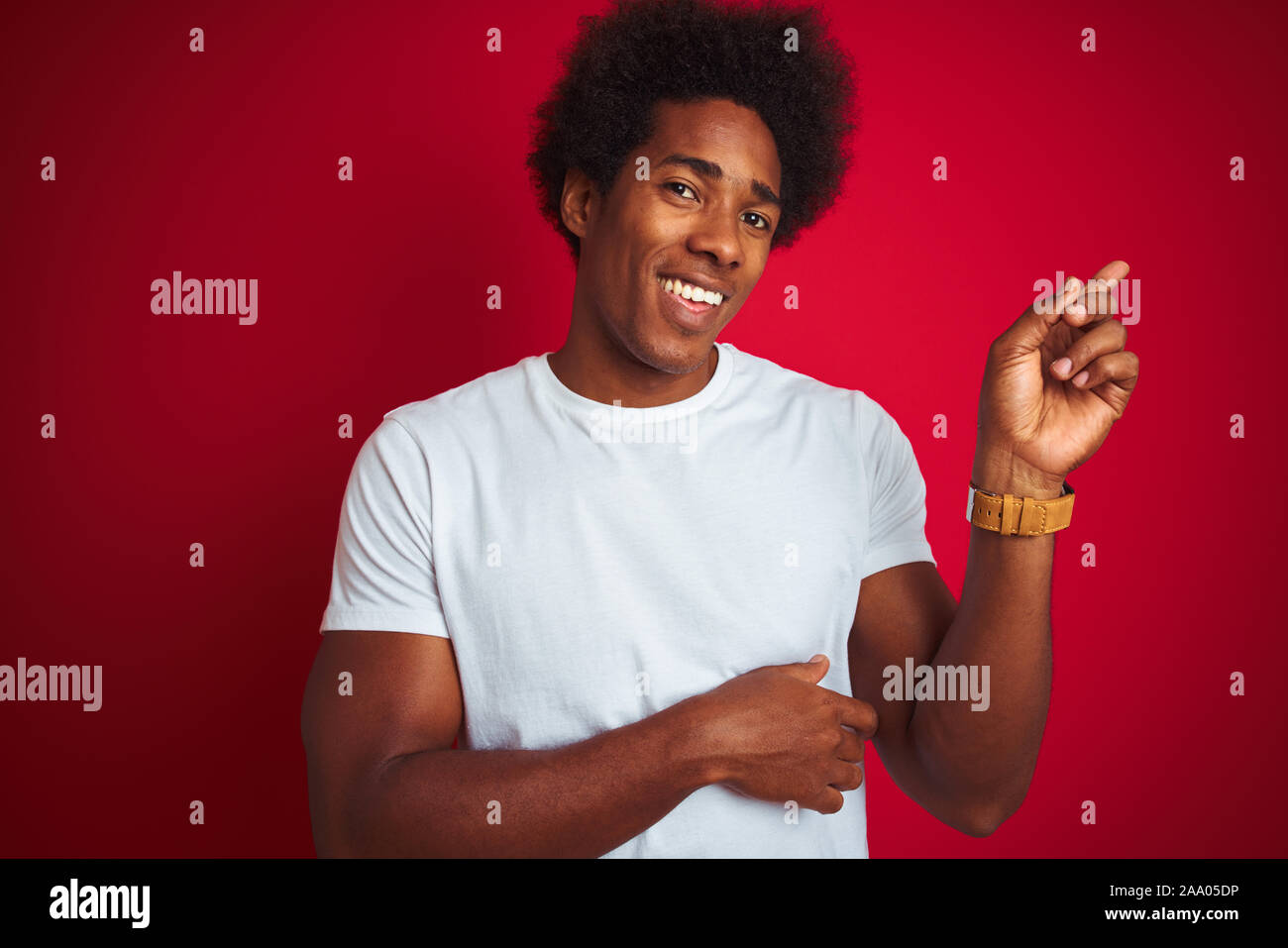 Young American Man With Afro Hair Wearing White T Shirt Standing