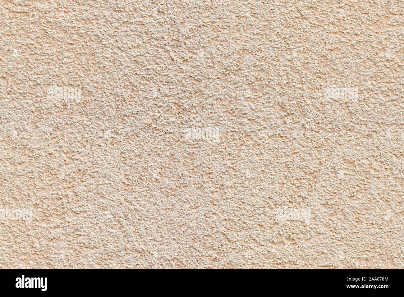 Fragment of a beige plastered wall with a fine texture. For use as an abstract background. Stock Photo