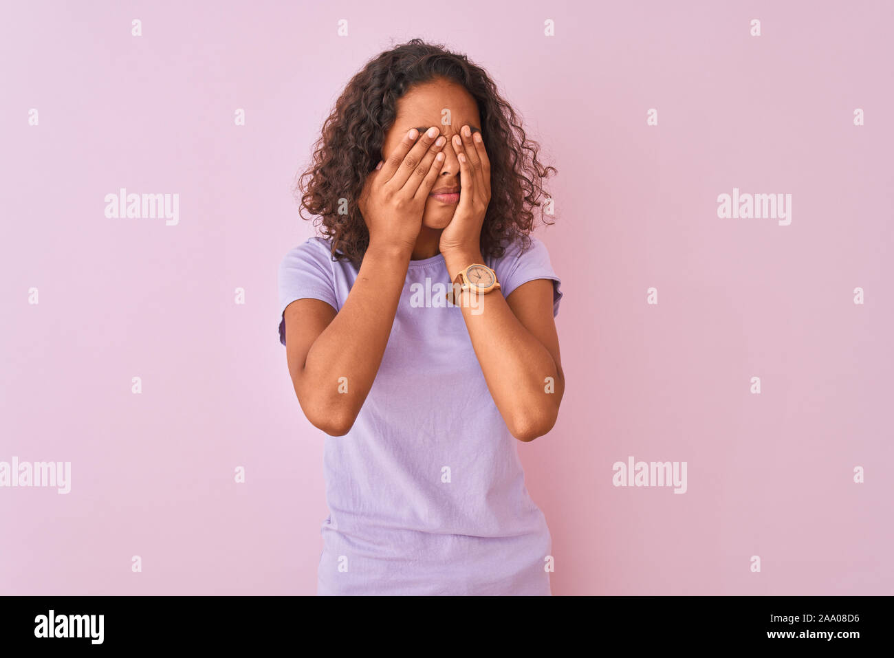 Young brazilian woman wearing t-shirt standing over isolated pink background rubbing eyes for fatigue and headache, sleepy and tired expression. Visio Stock Photo