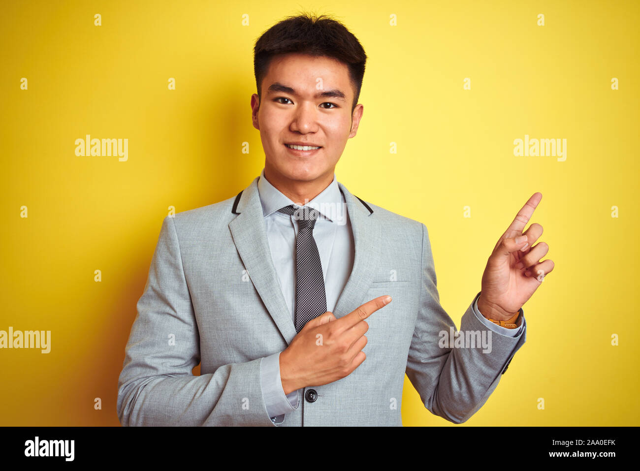 Asian chinese businessman wearing suit and tie standing over isolated ...