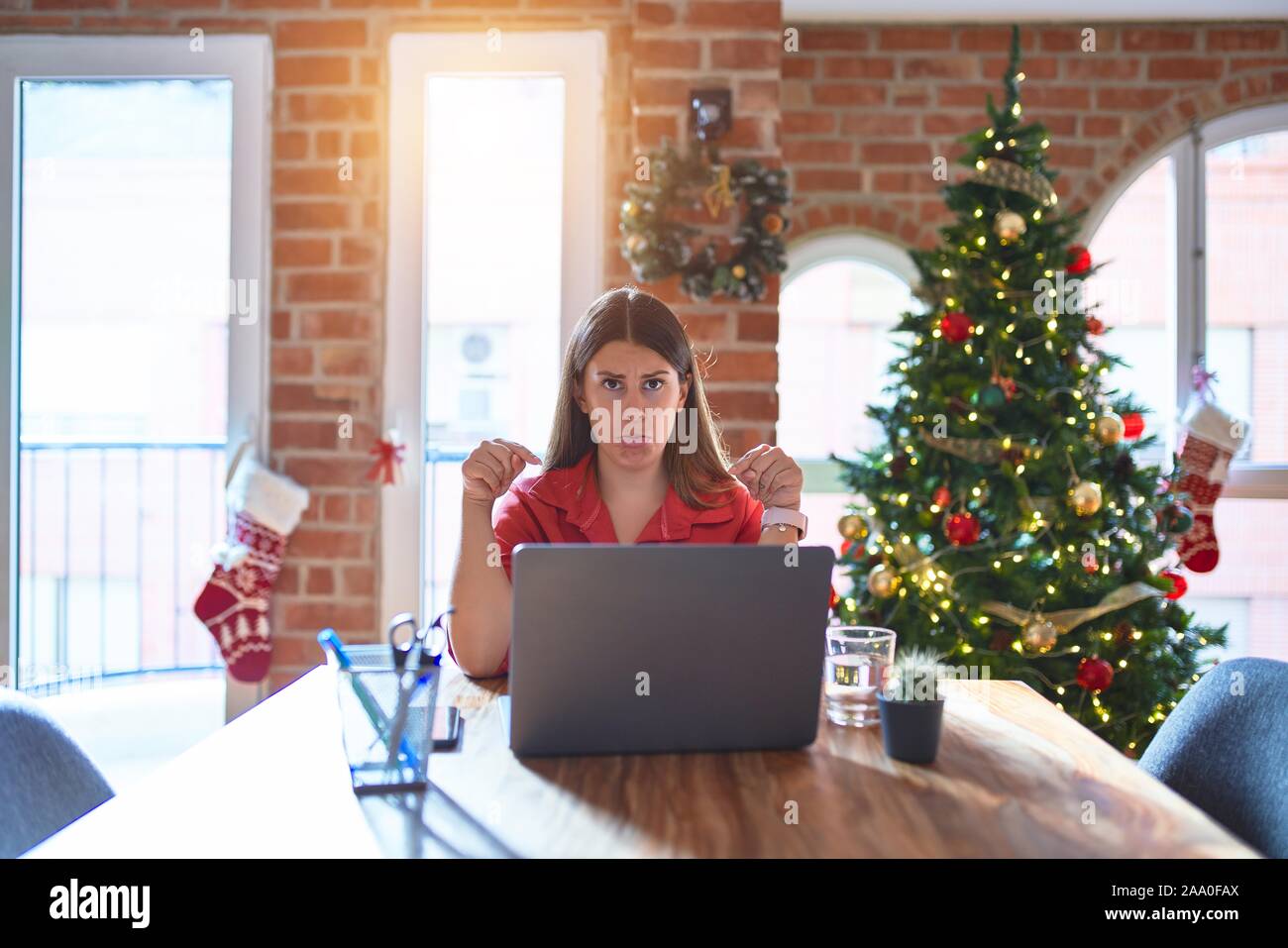 Beautiful Woman Sitting At The Table Working With Laptop At Home