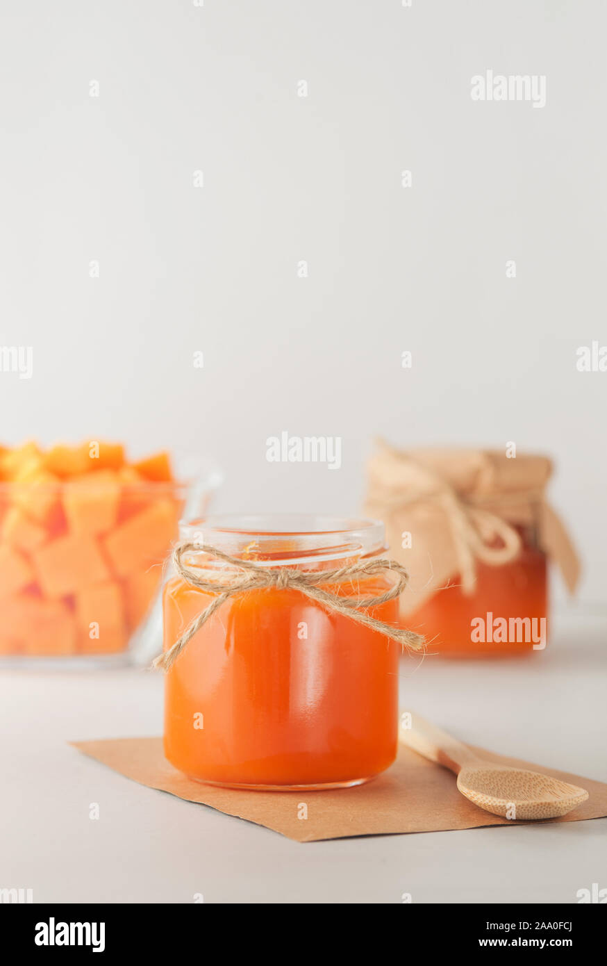 Homemade pumpkin jam in the glass jars. Selective focus.Autumn preserve.Image in vertical orientation with copy space. Stock Photo