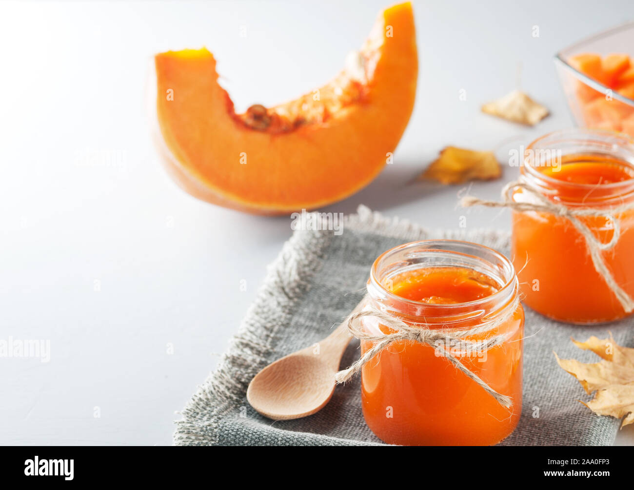 Homemade orange  pumpkin jam in a serving jars on the table. Sweet, yummy ,tasty dessert. Autumn dishes. Image with copy space,vertical orientation. Stock Photo