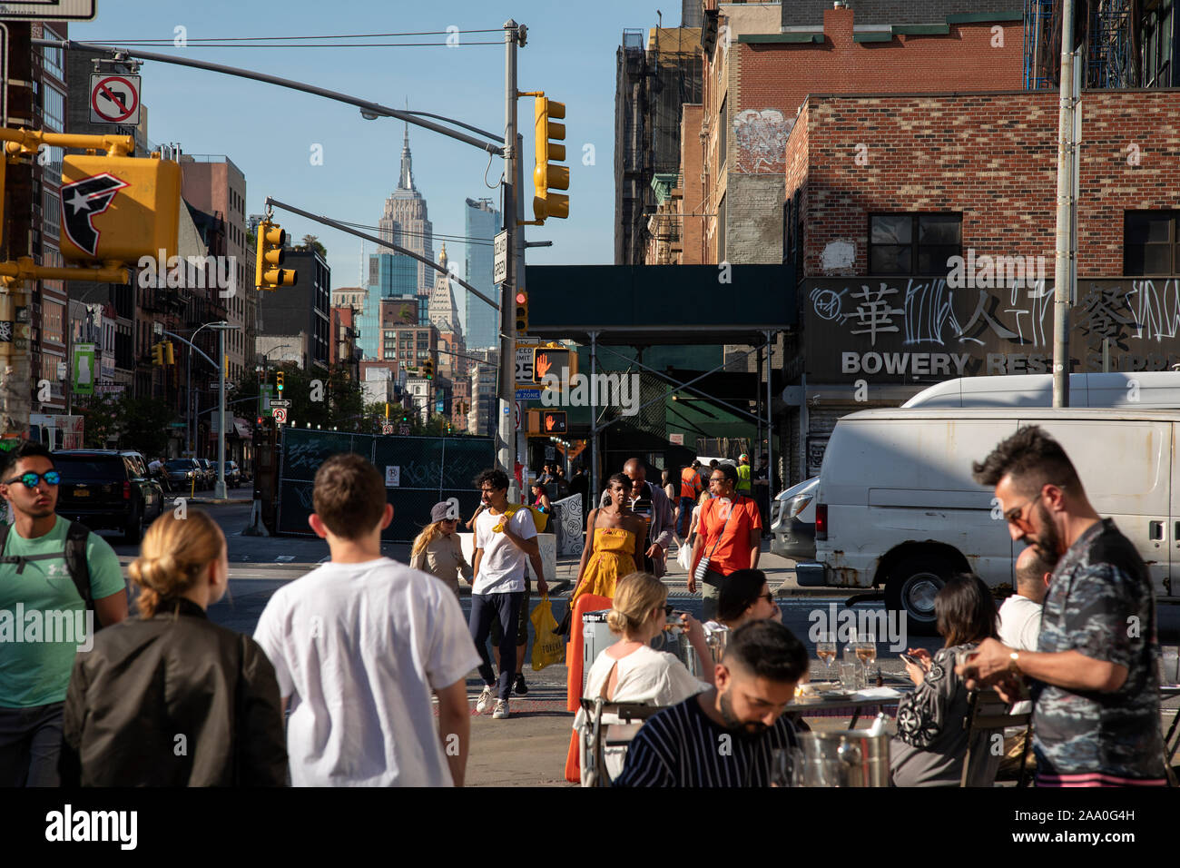 Busy street scene in Bowery, Manhattan, Empire State Bldg In Distance Stock Photo